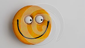 Smily face magnet on a fridge.