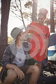 Smling couple looking at each other at forest