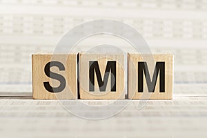 SMM abbreviation - social media marketing, on wooden cubes on a light background