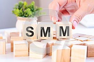 Smm concept with wooden blocks on table, business concept