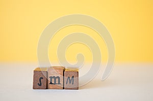 Smm letters on a bright yellow background