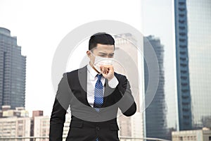 Smog in city.business man walking on street