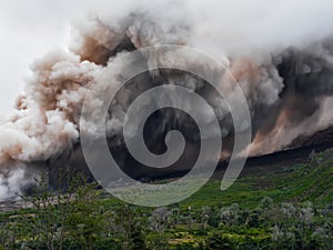 Smoke and ash from the volcano Sinabung is spread along the side