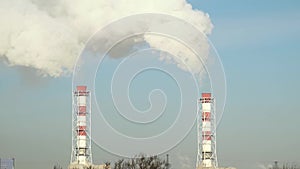 Smoke from boiler pipe on manufacturing factory. Industrial chimney smoke in blue sky. White smoke from industrial pipes