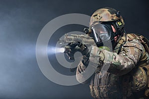 Smoke from chemical weapons and tear gas impair the visibility of a soldier in full military gear, helmet, bulletproof photo