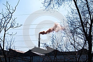 Smoke from the chimney of a chemical plant against the blue sky. The problem of environmental pollution. Ecology concept