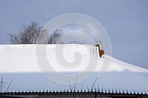 Smoke from the chimney. The smoking chimney of a residential building. Heating a private house in winter