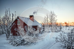 Smoke from the chimney of a Swedish house in winter