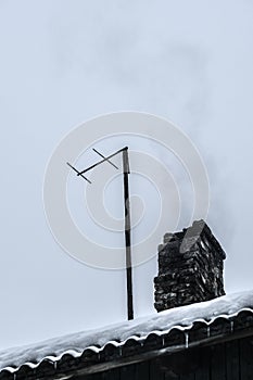 Smoke from the chimney of a village house