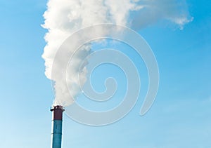 smoke from the chimneys against the blue sky