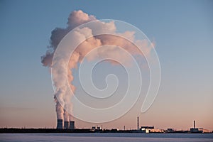 Smoke from chimneys of a thermal power plant in winter