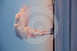 Smoke from chimneys of a thermal power plant in winter