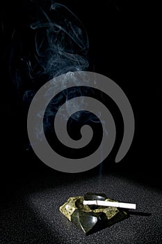 Smoke and cigarette in ashtray photo