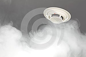 Smoke detector on ceiling, fire alarm in action