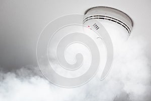 Smoke detector of fire alarm in action photo