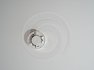 Smoke detector fire alarm detector, home security device installation at home on the ceiling.