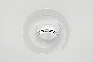 Smoke detector or fire alarm sensor on the ceiling.