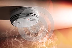 Smoke detector and interlinked fire alarm in action background