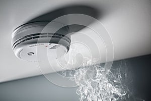 Smoke detector and interlinked fire alarm in action background