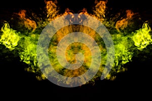 Smoke of different green, yellow, orange and red colors in the form of horror in the shape of the head, face and eye with wings on