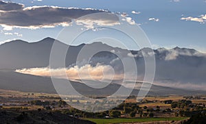 Smoke drifting at sunset from control burn in Salida Colorado USA photo