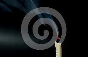 Smoke from extinguished candle. On Black background.
