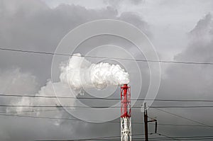 Smoke from the factory chimney. Ecological pollution. Industrial waste is hazardous to health.