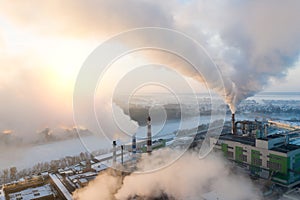 Smoke from factory chimneys on the background of sunrise