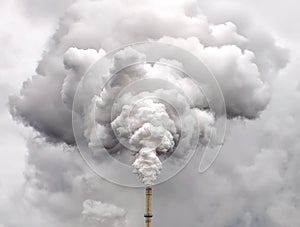 Smoke from factory pipe against overcast sky