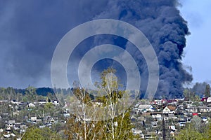 Smoke from a fire on the outskirts of the city in the private sector