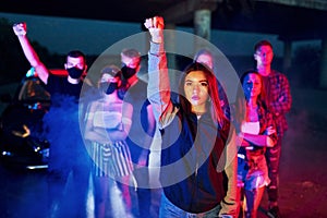 Smoke, fists, police. Group of protesting young people that standing together. Activist for human rights or against government