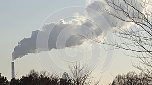 Smoke from industrial chimneys against the blue sky. Pollution