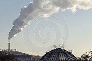 Smoke from industrial chimneys against the blue sky. Pollution