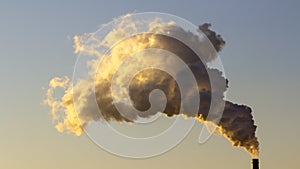 Smoke from industrial chimneys against the blue sky. Pollution