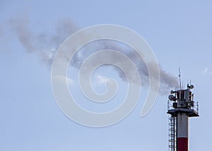 Smoke from industrial chimneys against the blue sky. Pollution