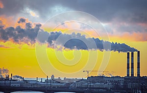 Smoke from industrial chimneys and a heavenly landscape at sunset