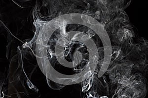 Smoke isolated on black background. Movement of white smoke