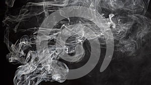 Smoke isolated on black background. Movement of white smoke