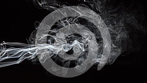 Smoke isolated on black background. Movement of white smoke