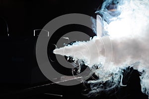 Smoke machine in action. Smoke in the dark.