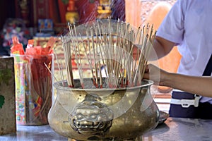 Smoke from many incense sticks that burning and embroidered in incense burner, Buddhists pray to be happy in the new year and ward