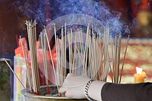 Smoke from many incense sticks that burning and embroidered in incense burner, Buddhists pray to be happy in the new year and ward