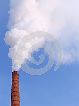 Smoke from a pipe in the winter cold afternoon photo