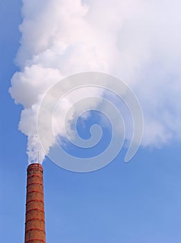 Smoke from a pipe in the winter cold afternoon