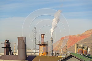 Smoke from Power Plant against mountain and sky