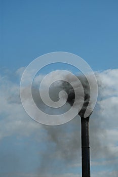 Smoke rising from tall chimney