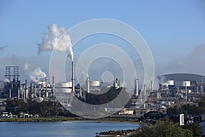 A smoke stack at an oil refinery