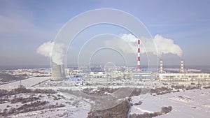 Smoke stacks and boiler pipes on power plant aerial landscape. Winter landscape white smoke from industrial pipe on