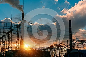 Smoke stacks at coal burning power plant, industrial silhouette.