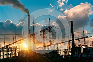 Smoke stacks at coal burning power plant, industrial silhouette.